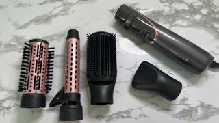 The Remington Curl and Straight Confidence Airstyler AS8606 handle with all the attachments surrounding it