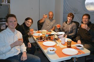 The HI-SEAS mock mission crew members dine together.