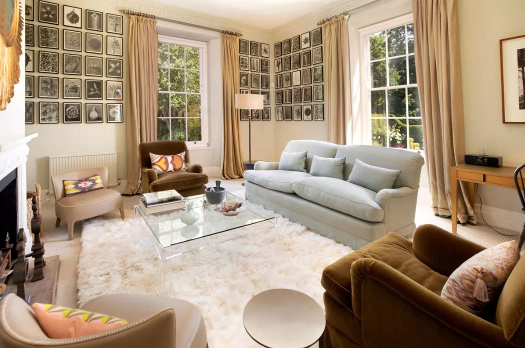 A view of the sitting room with cream sofa and large windows