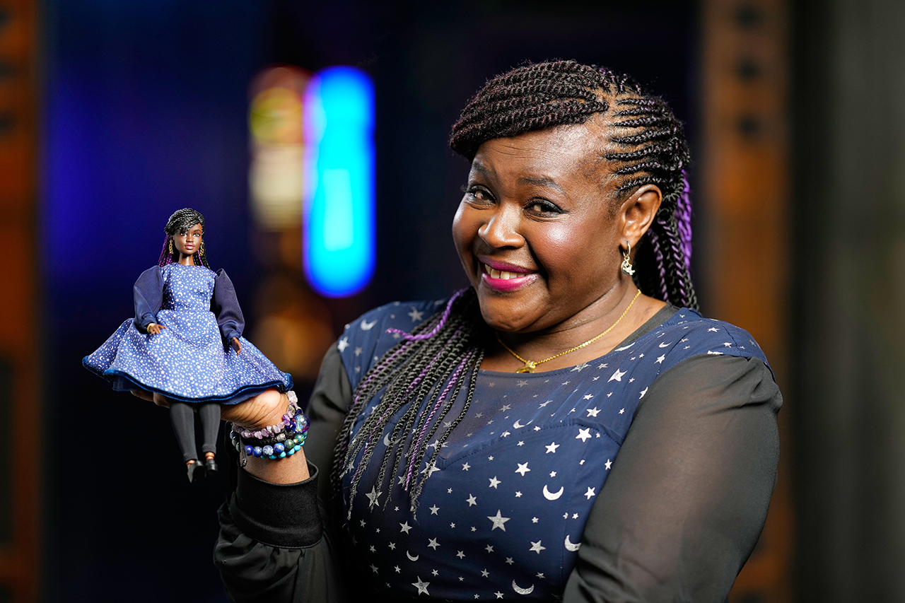 Maggie Aderin-Pocock presents her Barbie doll-self as one of the seven STEM role models recognized by Mattel