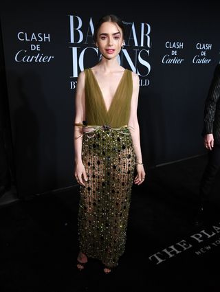 Lily Collins attend the ICONS By Carine Roitfeld event at The Plaza Hotel in New York City in 2019 wearing a sheer embellished Georges Hobeika couture dress and Cartier jewelry