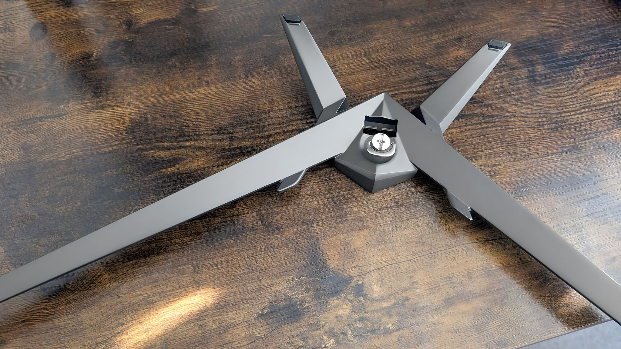 The underside of the Acer Predator XB273K's base with a built-in screw on a desk.