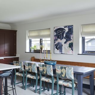 dining table with art canvas above in kitchen