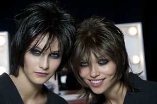 Dark haired models wearing dark make-up