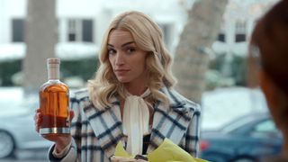 Brianne Howey as Georgia holding a bottle of liqour in Ginny & Georgia season 2