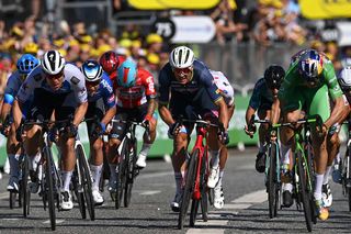 Caleb Ewan (Lotto Soudal) in the background looking down at his bike as podium finishers Fabio Jakobsen (QuickStep-AlphaVinyl), the green jersey clad Wout van Aert (Jumbo-Visma) second and Mads Pedersen (Trek Segafredo) battle at the front