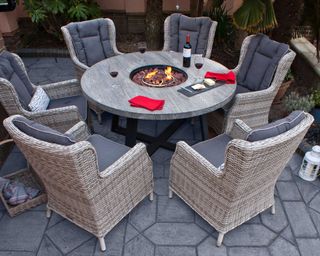 round outdoor dining table with fire pit from firmans