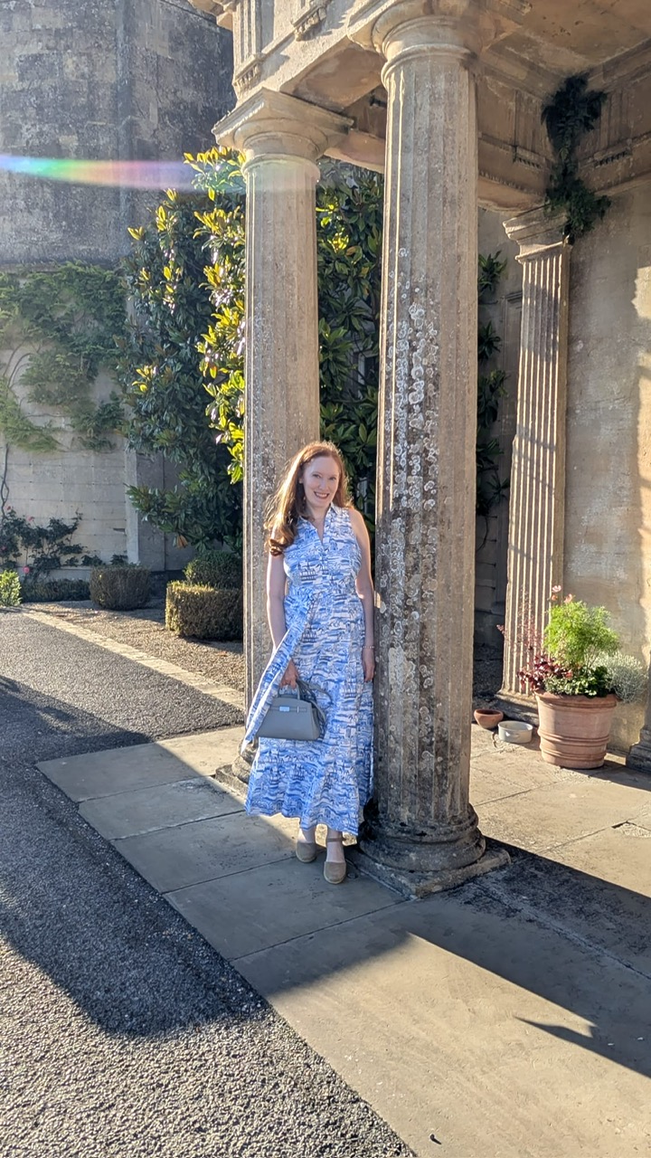 Kristin Contino standing in front of two pillars at Lucknam Park