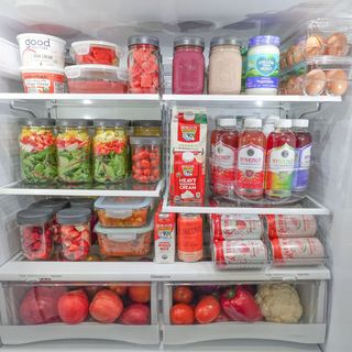 A colorful fridge with lots of items in storage containers