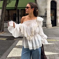 \Woman wears white blouse, jeans, sunglasses
