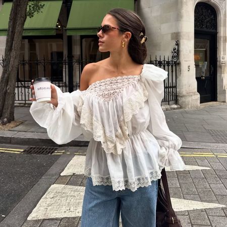 \Woman wears white blouse, jeans, sunglasses