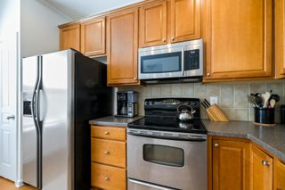 Image of a brown kitchen with stainless steel appliances