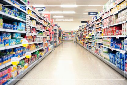 fully stocked supermarket shelves with empty aisle
