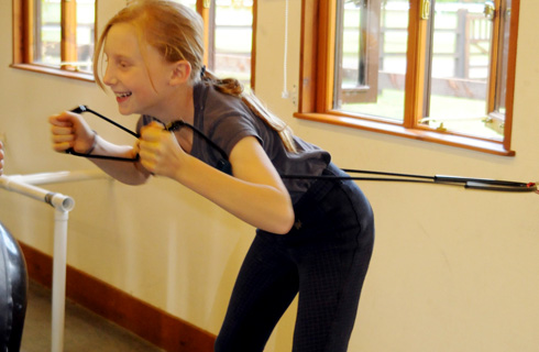 Stretch for success: a child gets to grips with the fitness a equipment