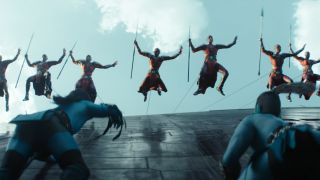 The Dora Milaje descend on some intruders at a wall in Black Panther: Wakanda Forever.