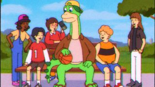 a dinosaur surrounded by children Saturday Morning All Star Hits