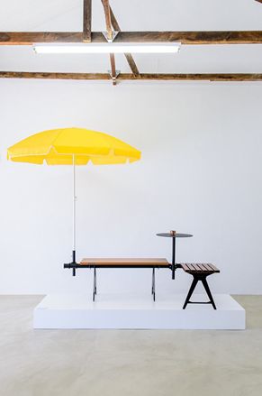 Wooden bench with yellow umbrella