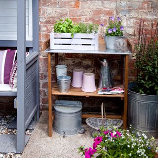 concrete patio with potting shelving and pots