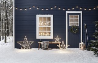 Christmas window decor with fairy lights and candles