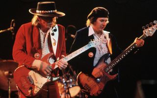 Stevie Ray Vaughan (left) and Tommy Shannon perform onstage