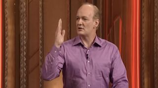 Colin Mochrie performing a press conference on Whose Line Is It Anyway?