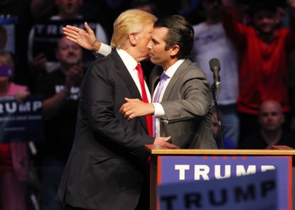 Donald Trump Jr. hugs his father at a campaign event