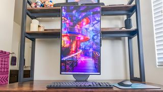 The Lenovo Yoga AIO 27" sitting on a desk with the display in portrait mode.