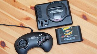 The Genesis Mini and its controller next to an actual Genesis cartridge, for scale.