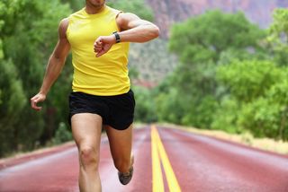 A man out for a run checks his smartwatch.