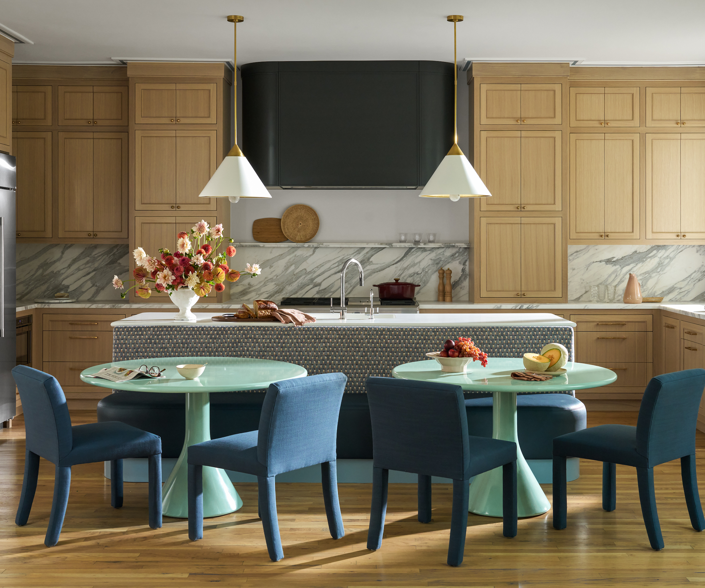 wood kitchen with tiled island and two dining sets