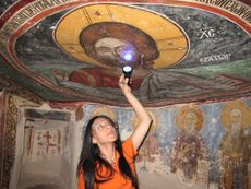 The researchers analyzed some of the paintings on site using various techniques, including infrared, ultraviolet and X-ray fluorescence imaging. Here, UCLA archaeologist Ioanna Kakoulli examines a painting in the monastery under UV light.