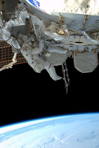 ESA Astronaut Paoli Nespoli snapped this photo of Discovery shuttle astroanuts Alvin Drew and Steven Bowen during the first spacewalk of their STS-133 mission on Feb. 28, 2011.