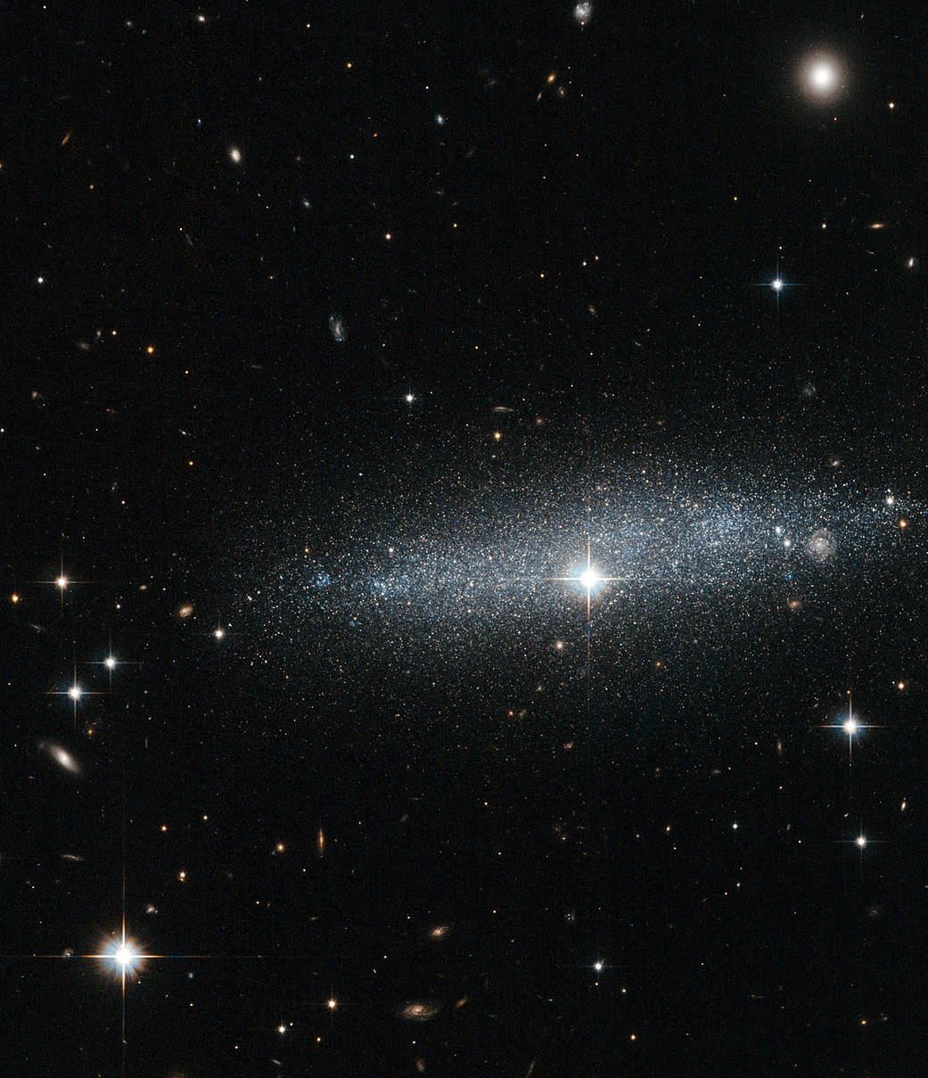 A wide view of the twinkling dwarf galaxy with bright stars all around.