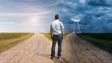 Man standing in fork in the road between good and bad weather