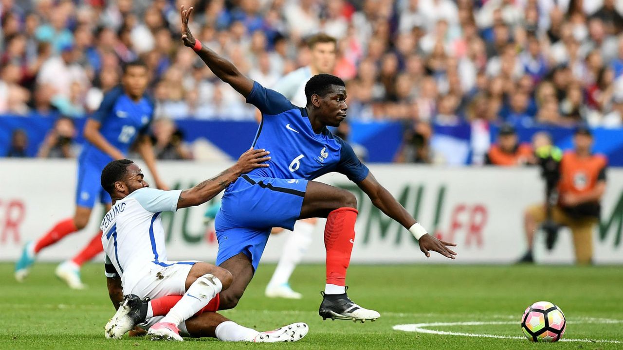 Paul Pogba of France battles with England&amp;#039;s Raheem Sterling in Paris