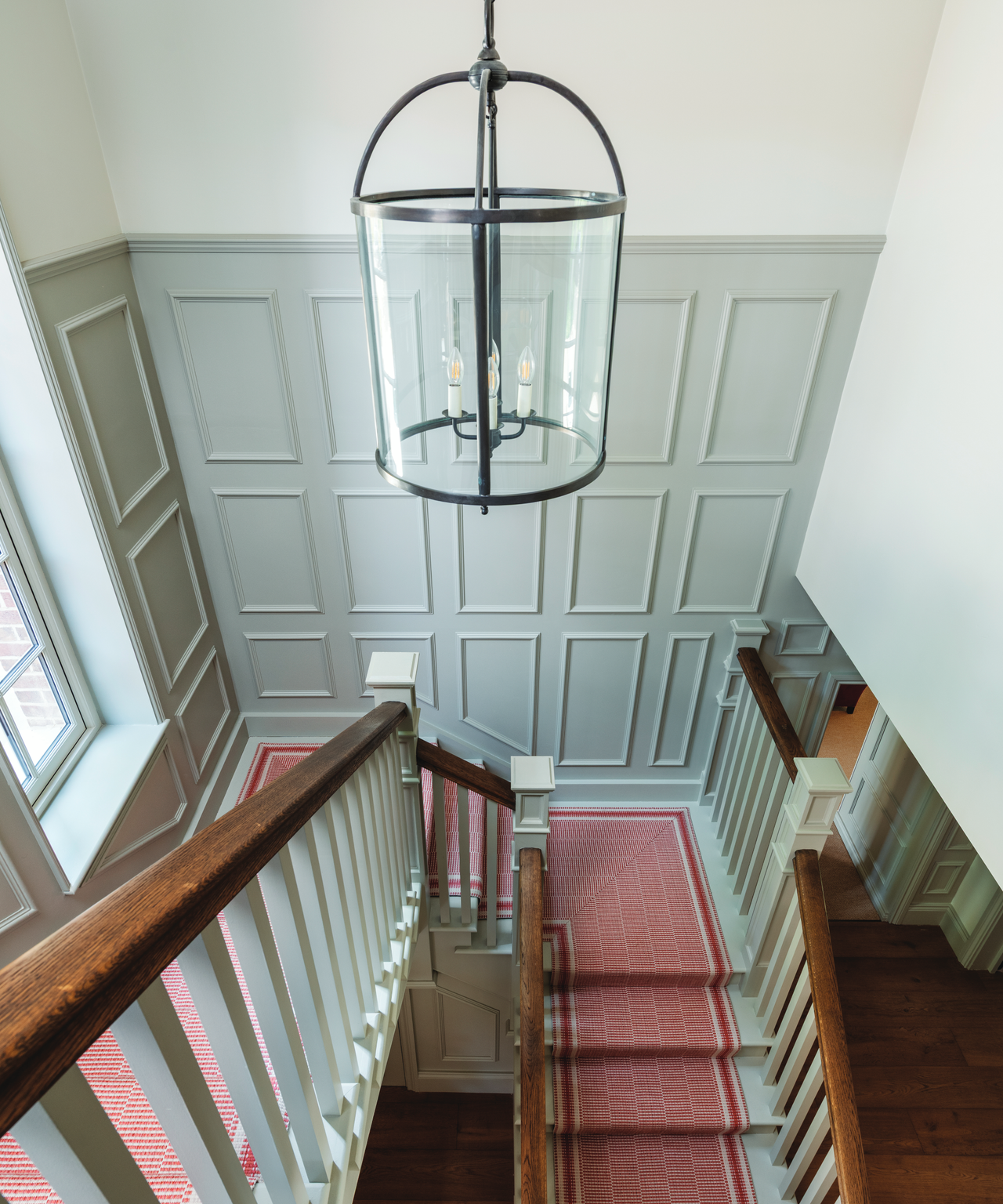 top of the staircase with a grey panelled back wall