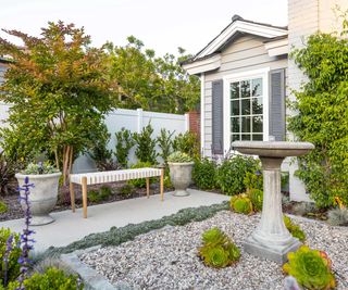 front yard with gravel and water feature