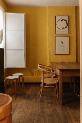 Yellow- walled interior with chairs and table