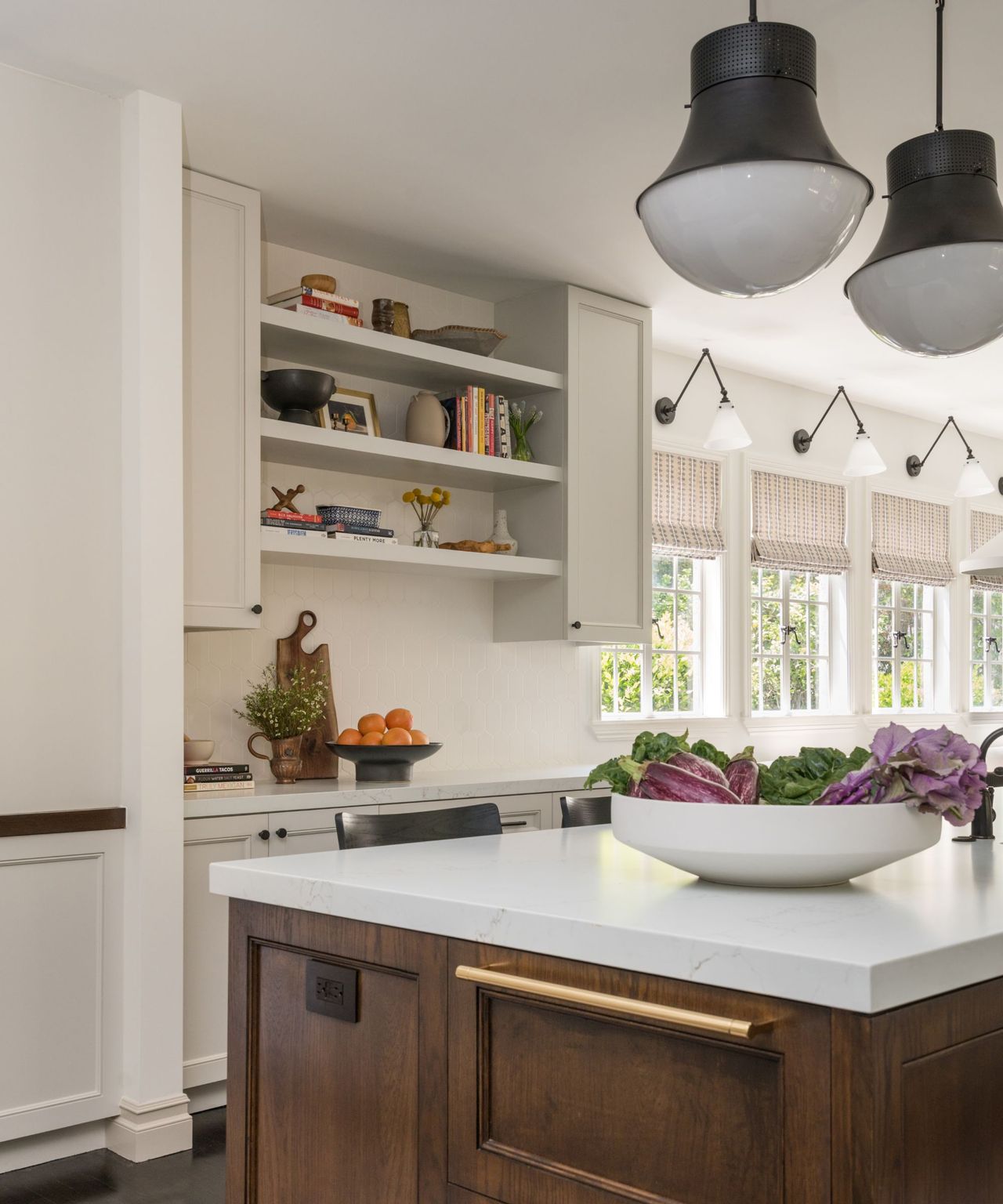 A well-lit, open-plan kitchen with an island and windows