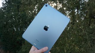 Apple iPad Air 2022 in one hand back