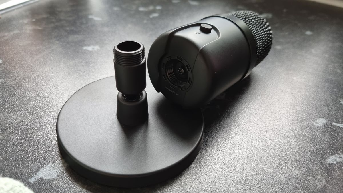 The Amazon Basics USB Condenser microphone detached from its stand, showing the socket connection underneath