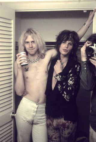 Tom Hamilton and Steven Tyler of Aerosmith posing backstage in 1973 in Newport, Rhode Island.