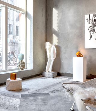 Copper lamps and sculptures in grey room
