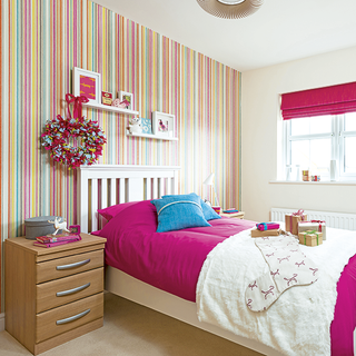 spare bedroom with wallpaper and rose pink bedlinen