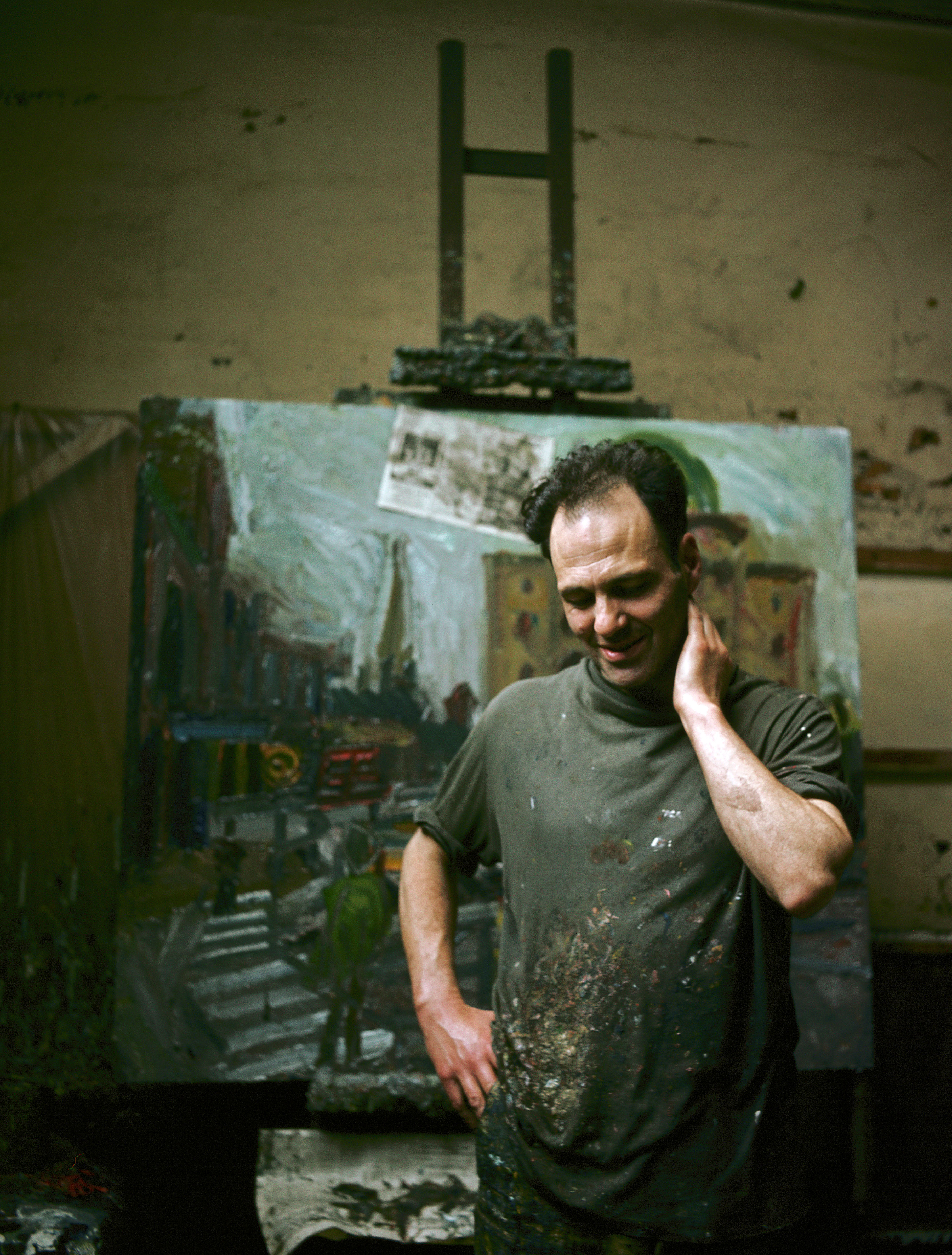 Frank Auerbach standing infront of one of his paintings
