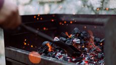 Close-up of charcoal burning in barbecue grill 