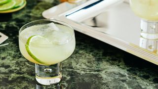 side shot of a green cocktail on a green marble counter