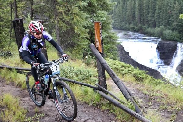 A rider pushes on alongside the raging river on stage six of the TransRockies