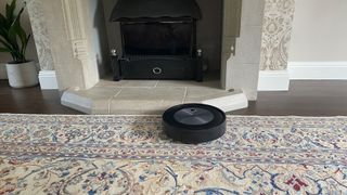 irobot j7+ on a rug in a living room