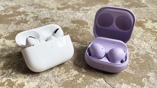Galaxy Buds 2 Pro and AirPods Pro side-by-side on a stone surface